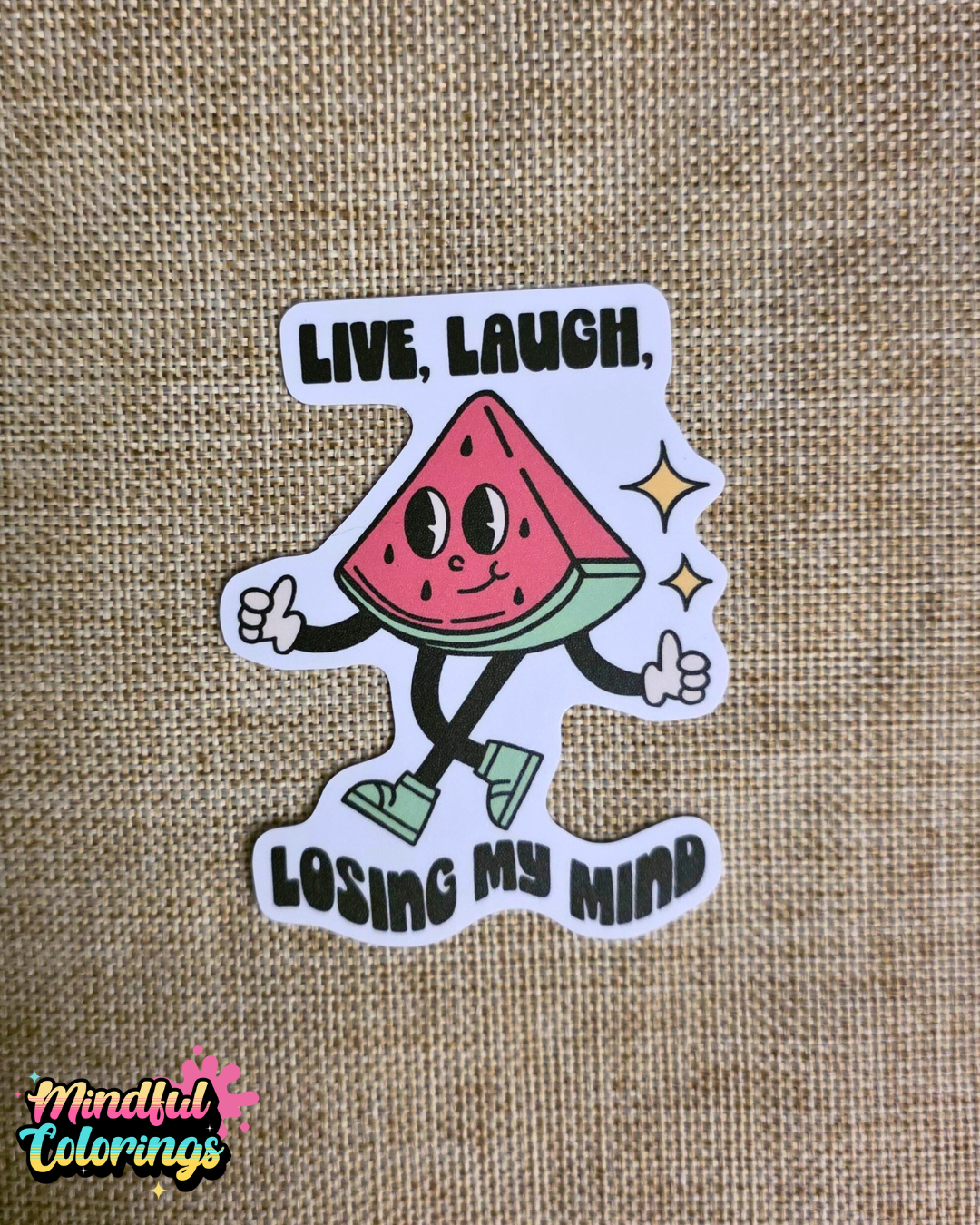 Sticker with a watermelon character and text 'Live, Laugh, Losing My Mind' on a textured brown background.