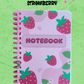 Notebook with strawberry pattern on a green background