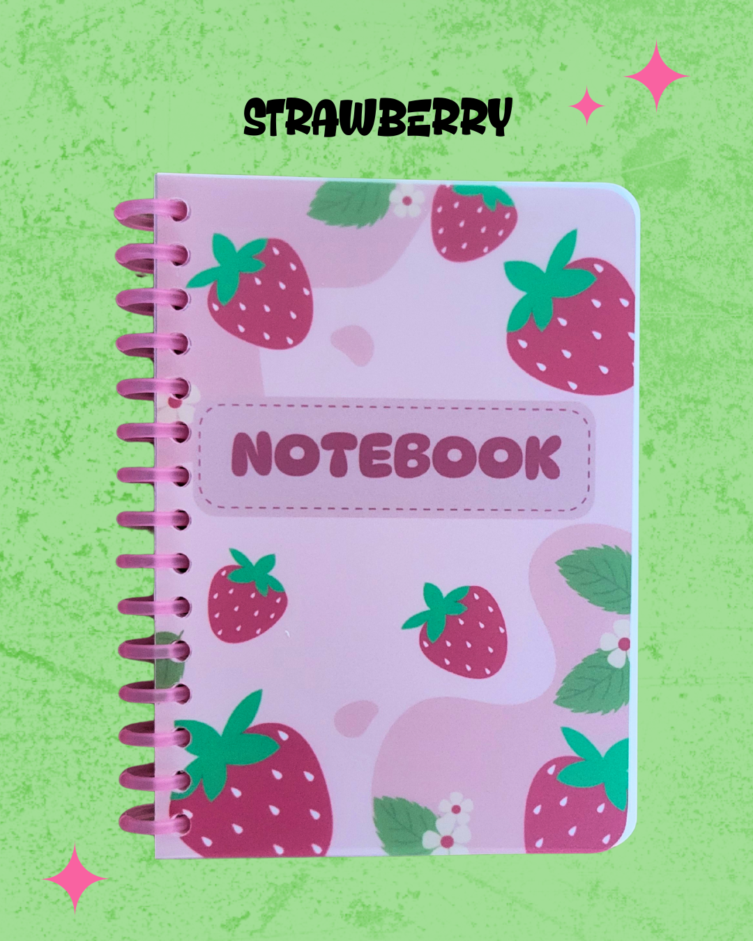 Notebook with strawberry pattern on a green background