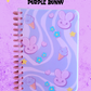 Notebook with purple bunny and ice cream designs on a purple background