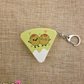 Cheese shaped fidget keychain with cartoon olives on the front