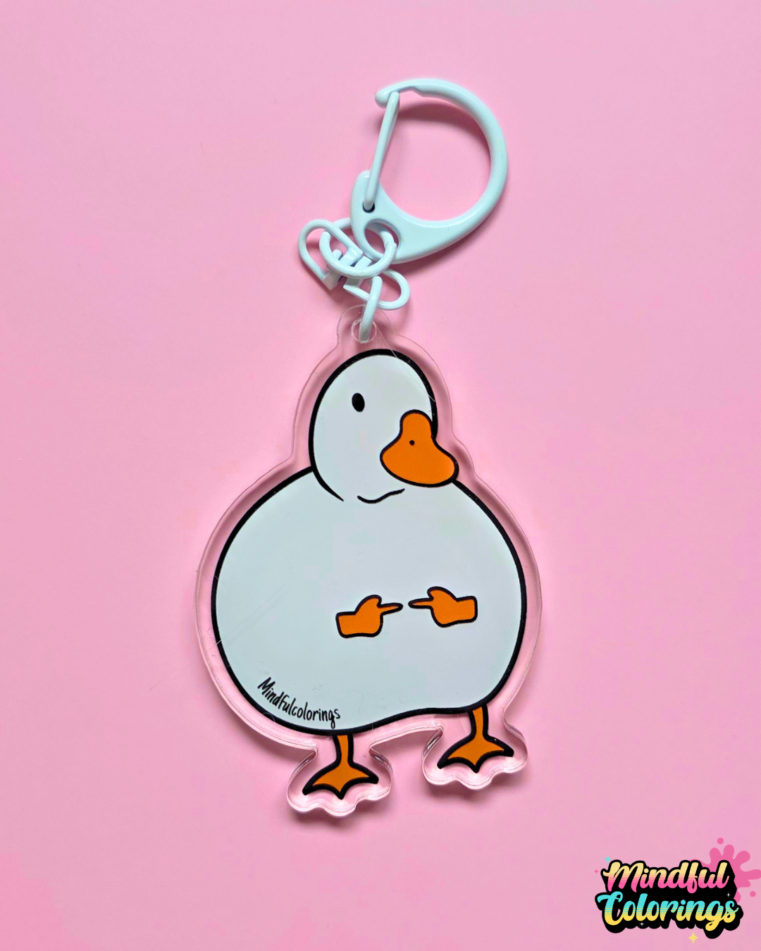 Clear acrylic keychain featuring a round white duck holding up two tiny middle fingers with a white D-hook clasp against a pink background.