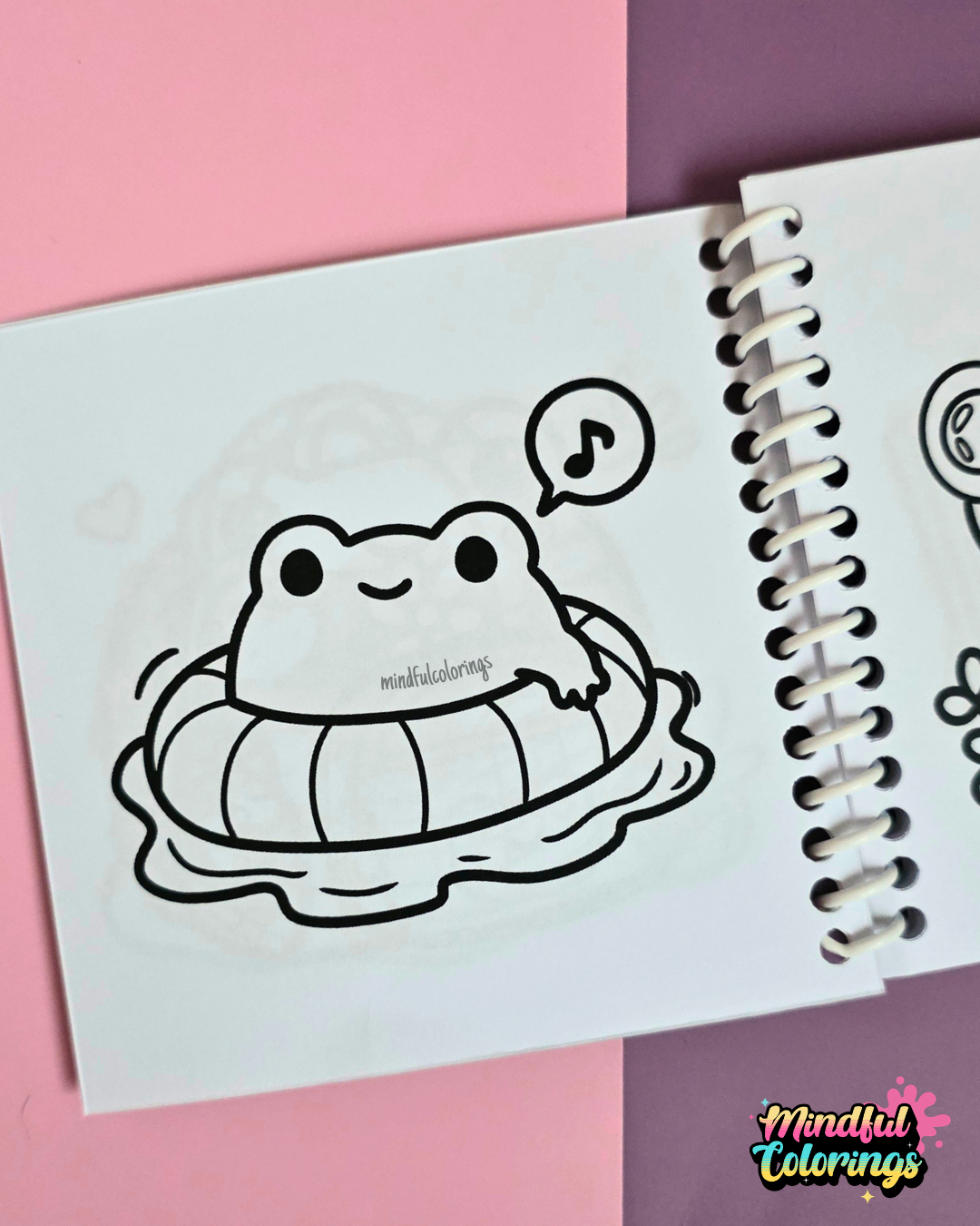 Mini frog-themed colouring book page featuring a happy frog floating in an inflatable swim ring while relaxing in the water and listening to music.