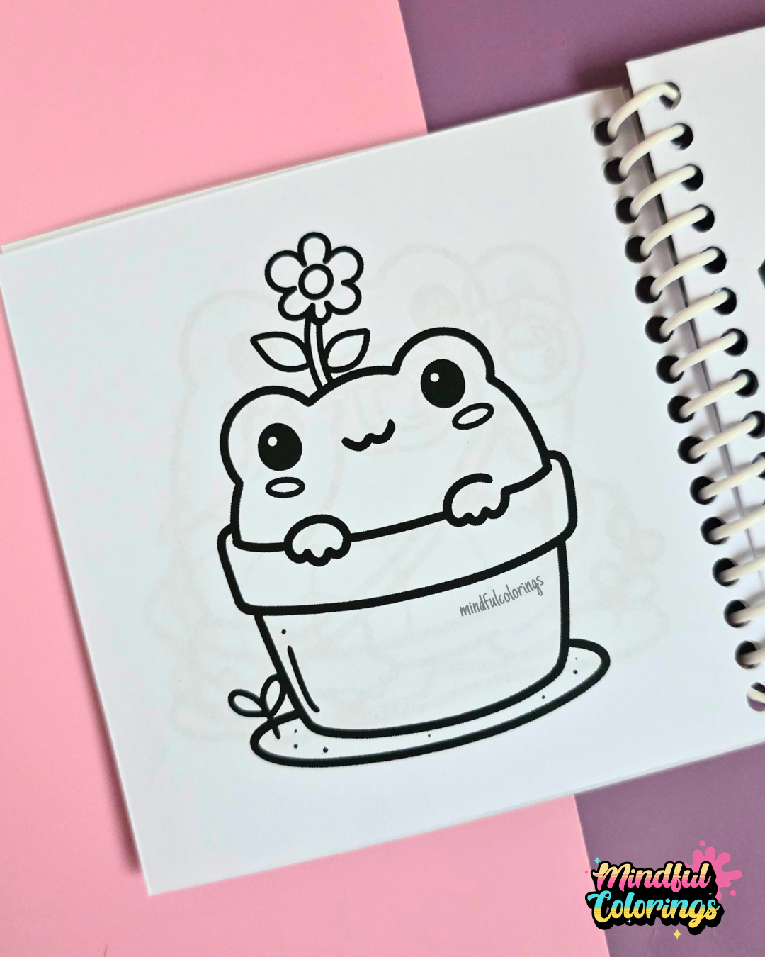 Mini frog-themed colouring book page featuring a cute frog sitting inside a flower pot with a flower blooming from its head.