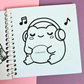 Mini frog-themed colouring book page featuring a peaceful frog wearing headphones while listening to music.