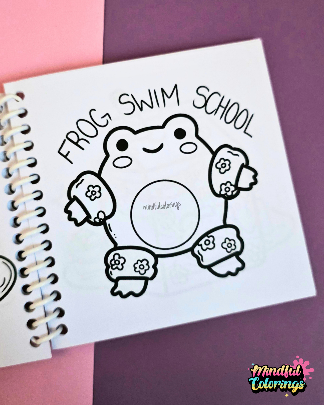Mini frog-themed colouring book page featuring a happy frog wearing floral arm floaties and leg floaties with the words "Frog Swim School" above.