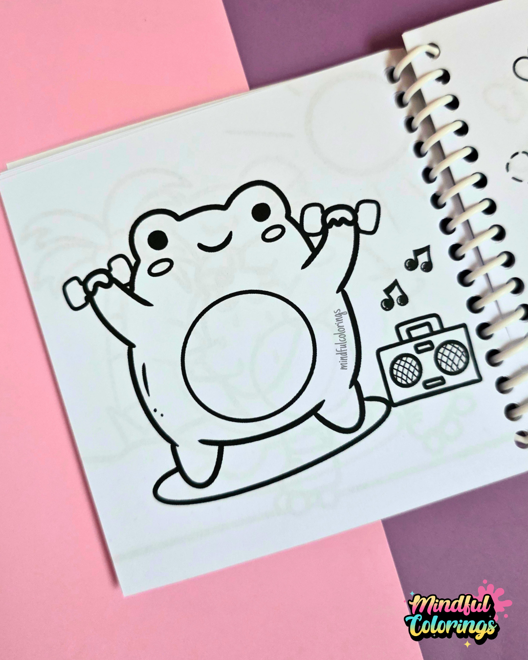 Mini frog-themed colouring book page featuring a happy frog lifting small dumbbells while exercising beside a boombox playing music.