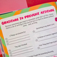 Colorful gratitude journal with prompts on a pink background