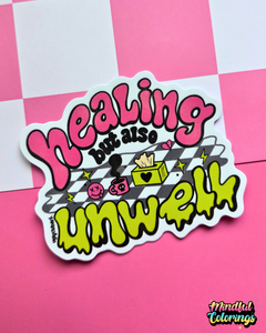 Waterproof vinyl sticker featuring the phrase "Healing but also unwell" in colorful bubble lettering with playful illustrations on a pink checkered background.