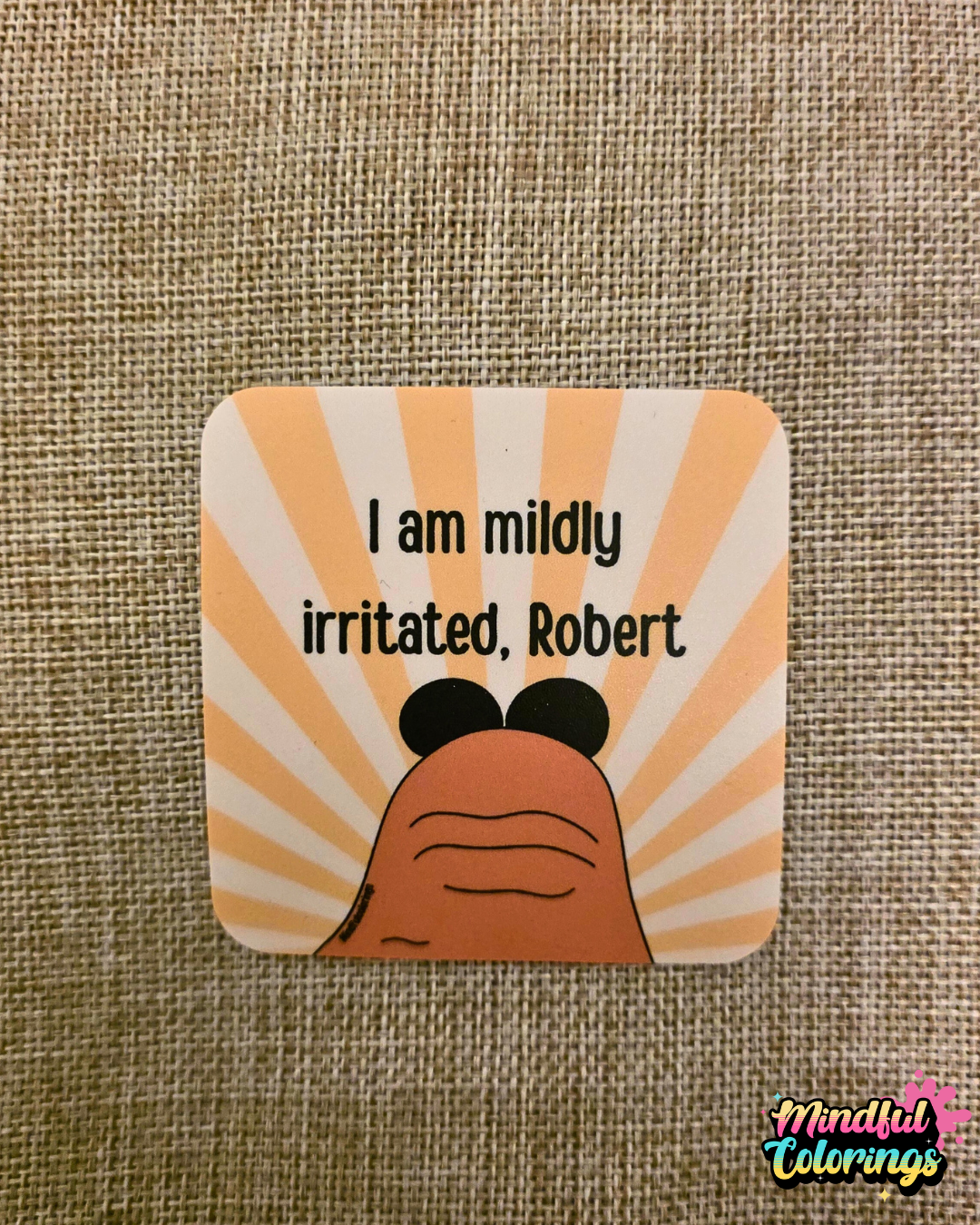 Sticker featuring Marcus the Worm with the text "I am mildly irritated, Robert" on a yellow sunburst background.