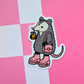 Cute opossum vinyl sticker holding an iced coffee and wearing pink platform boots with a matching heart purse on a pink background.