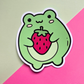 Waterproof vinyl sticker featuring a cute green frog holding a large strawberry on a pink and mint background.