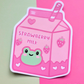 Waterproof vinyl sticker featuring a pink strawberry milk carton with a smiling frog illustration on a pink and mint background.