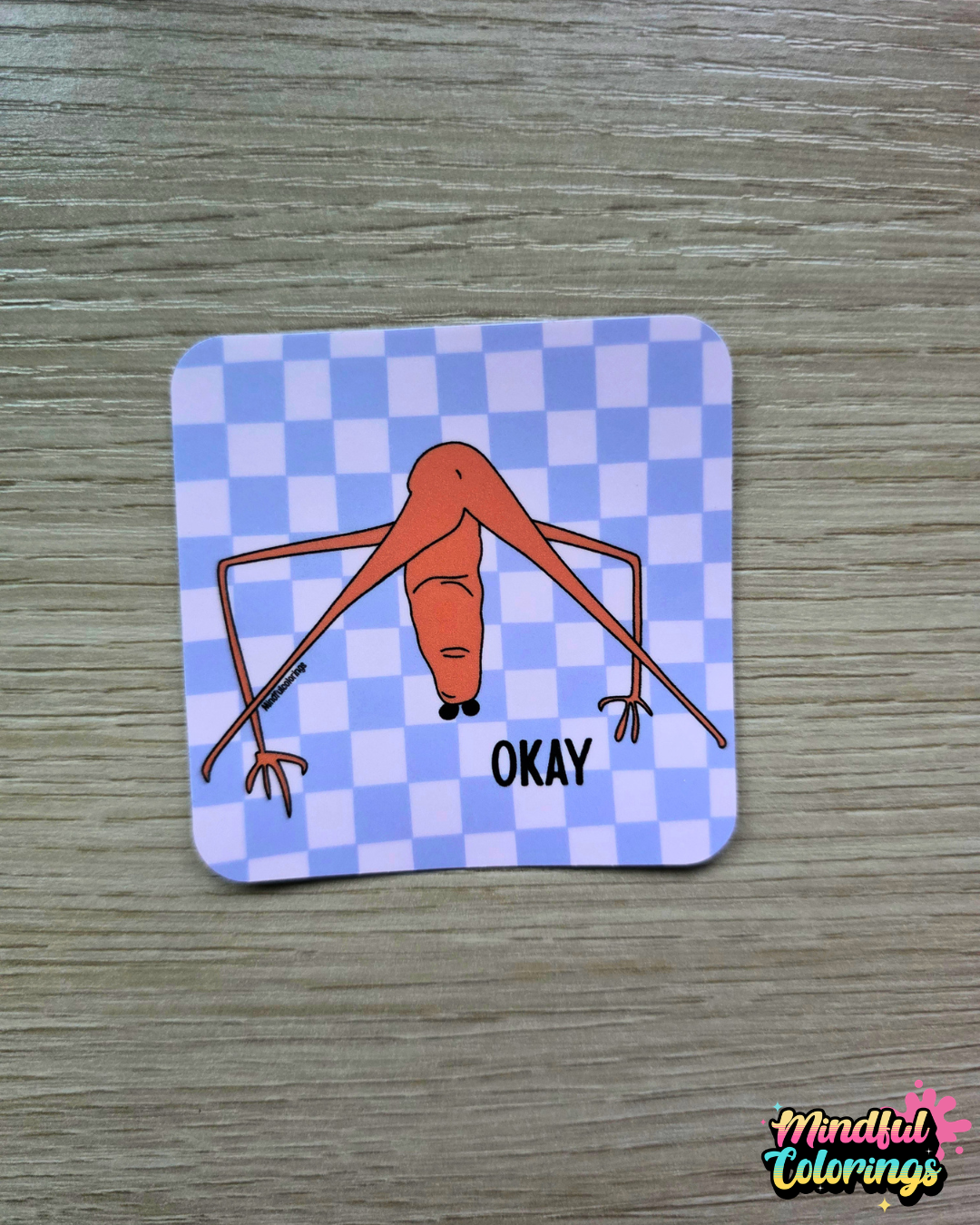 Sticker with viral Marcus the Worm design and 'OKAY' text on a  purple checkered background