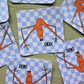 Stickers with viral Marcus the Worm design and 'OKAY' text on a checkered background