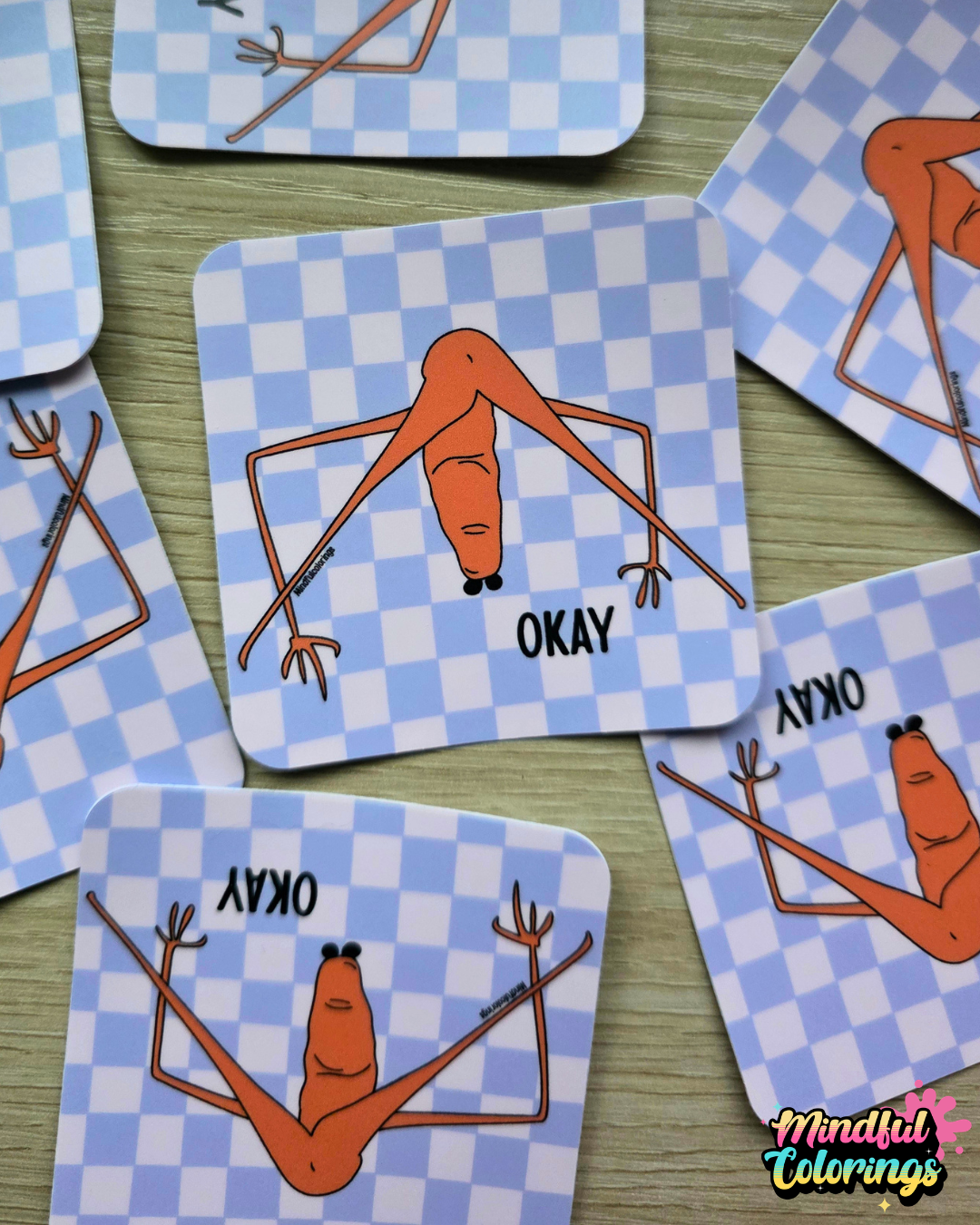 Stickers with viral Marcus the Worm design and 'OKAY' text on a checkered background