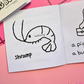 Mini coloring book with a shrimp drawing with text that says " Shramp" 