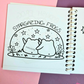 Mini frog-themed colouring book page featuring two frogs sitting together and stargazing beneath a sky full of stars.