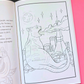 An open coloring book or art journal showing a black-and-white line drawing of a cat-shaped cityscape with stars and a moon, placed on a pink background with a black section visible on the left.