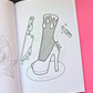 An open coloring book or art booklet showing black-and-white line art of a high-heeled boot, a knife, and lipstick on a pink and black background. A 'Mindful Colorings' logo appears in the bottom right corner.
