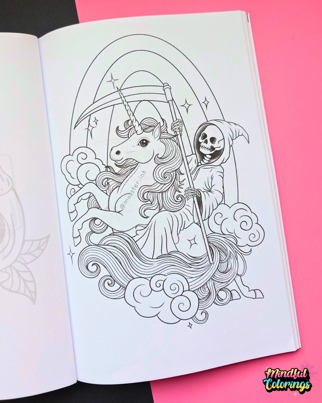 An open coloring book or art journal showing a black-and-white line drawing of a unicorn with a scythe and a hooded grim reaper, placed on a bright pink background with a small 'Mindful Colorings' logo in the corner.