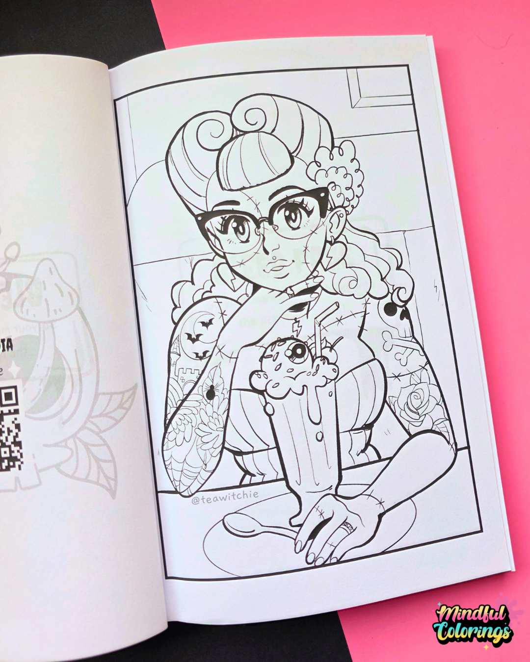 An open coloring book showing a black-and-white illustrated page with a retro-style woman spooky, holding a milkshake, placed on a pink and black background. A 'Mindful Colorings' logo appears in the bottom right corner.