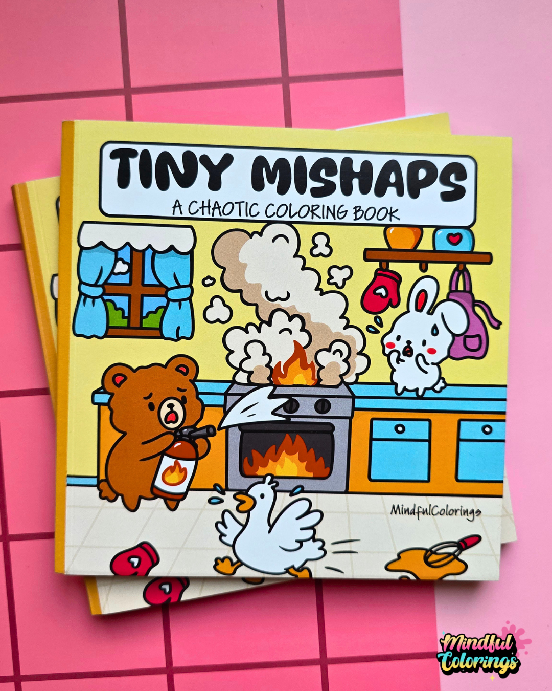 Cover of Tiny Mishaps: A Chaotic Coloring Book featuring adorable animals reacting to a kitchen fire in a colorful cartoon illustration.