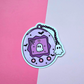 Cute Y2K virtual pet vinyl sticker featuring a pixel ghost inside a purple device with bats, spiderwebs and a tiny ghost charm.