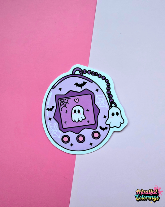 Cute Y2K virtual pet vinyl sticker featuring a pixel ghost inside a purple device with bats, spiderwebs and a tiny ghost charm.