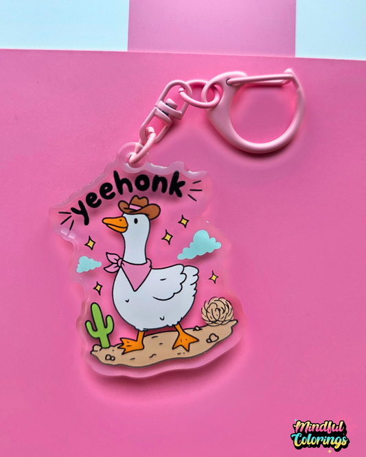 Acrylic keychain featuring a goose wearing a cowboy hat and pink bandana with the word "Yeehonk" on a pink background.