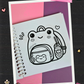 Cute frog-shaped backpack with small accessories and decorative details coloring page from the Frogcore Adventures mini coloring book.