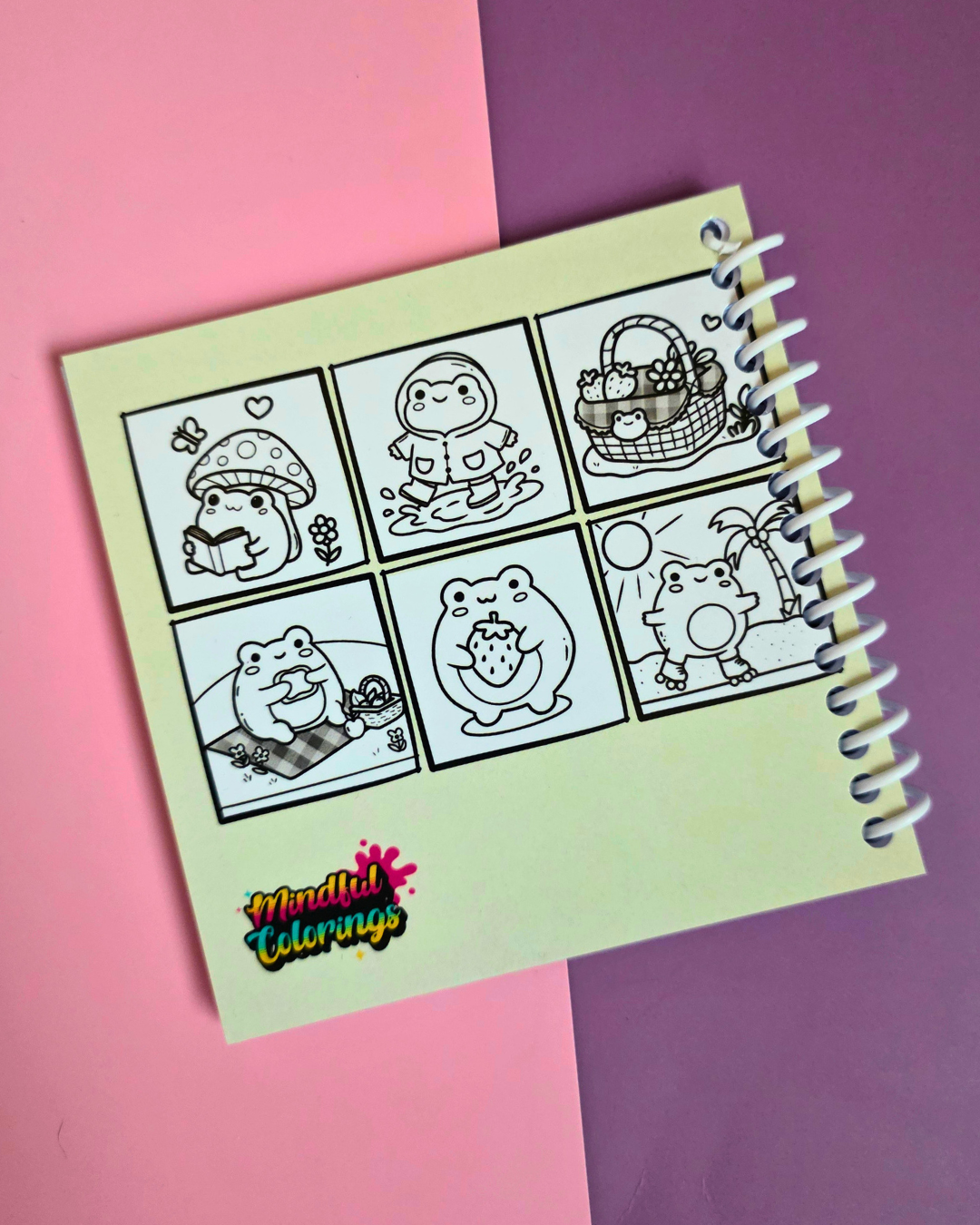 Mini 4x4-inch Frogcore Adventures coloring book featuring cute frog-themed illustrations, coiled binding, and 46 double-sided pages filled with whimsical frog adventures and cozy nature-inspired scenes.